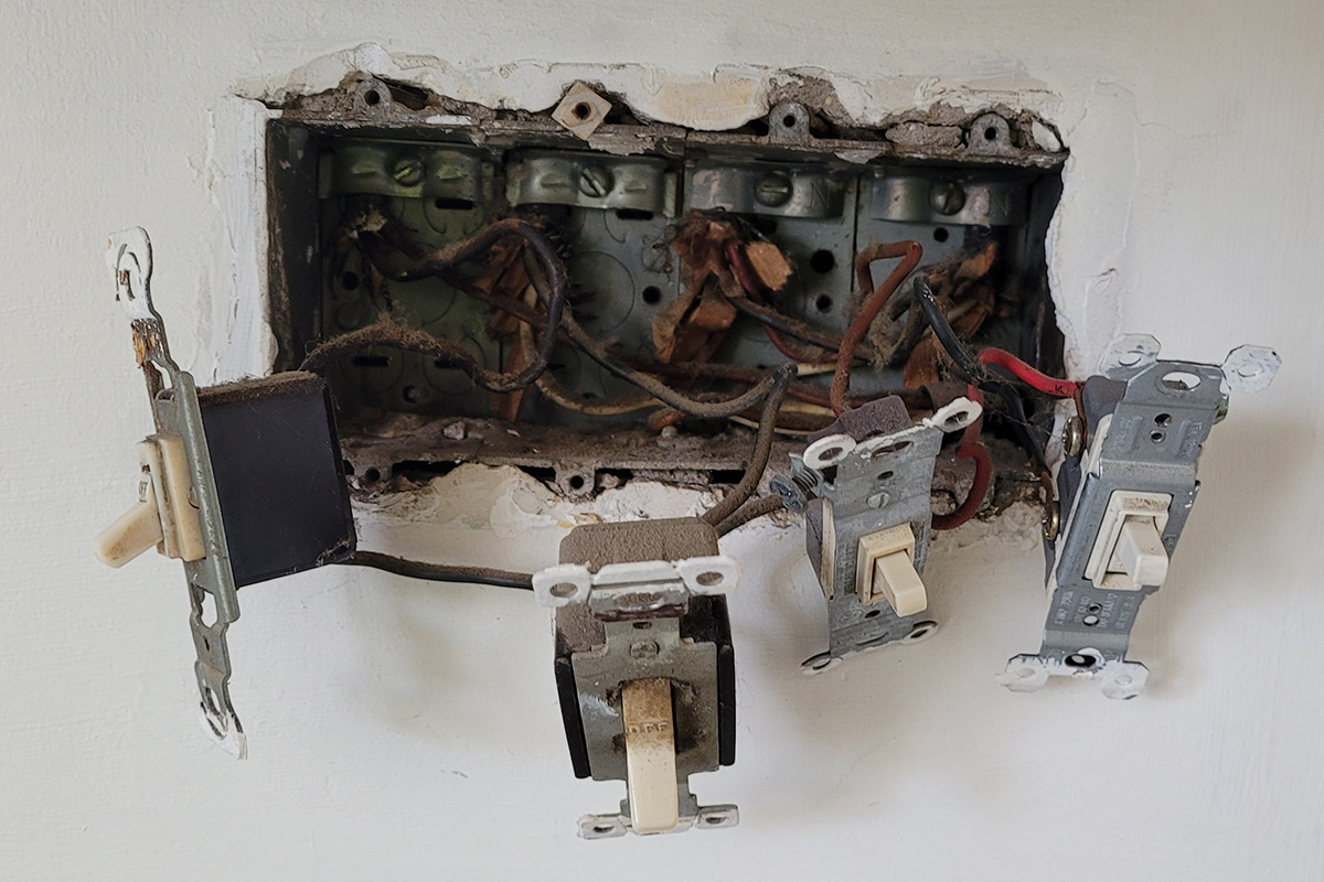 Old fuse box switches replaced by Bergeron Contracting electrician during panel upgrade Worcester MA